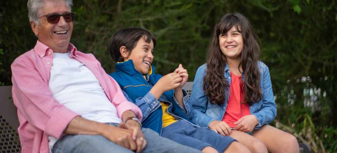 a grandfather spending time with his grandchildren at a park